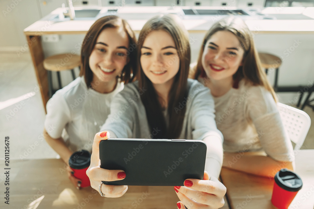 Three young women having fun and taking selfie Three young women having fun and taking selfie
