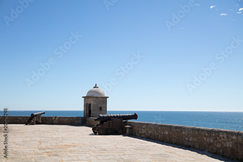 Cannons overlooking ocean at fort of São Francisco do Queijo photo