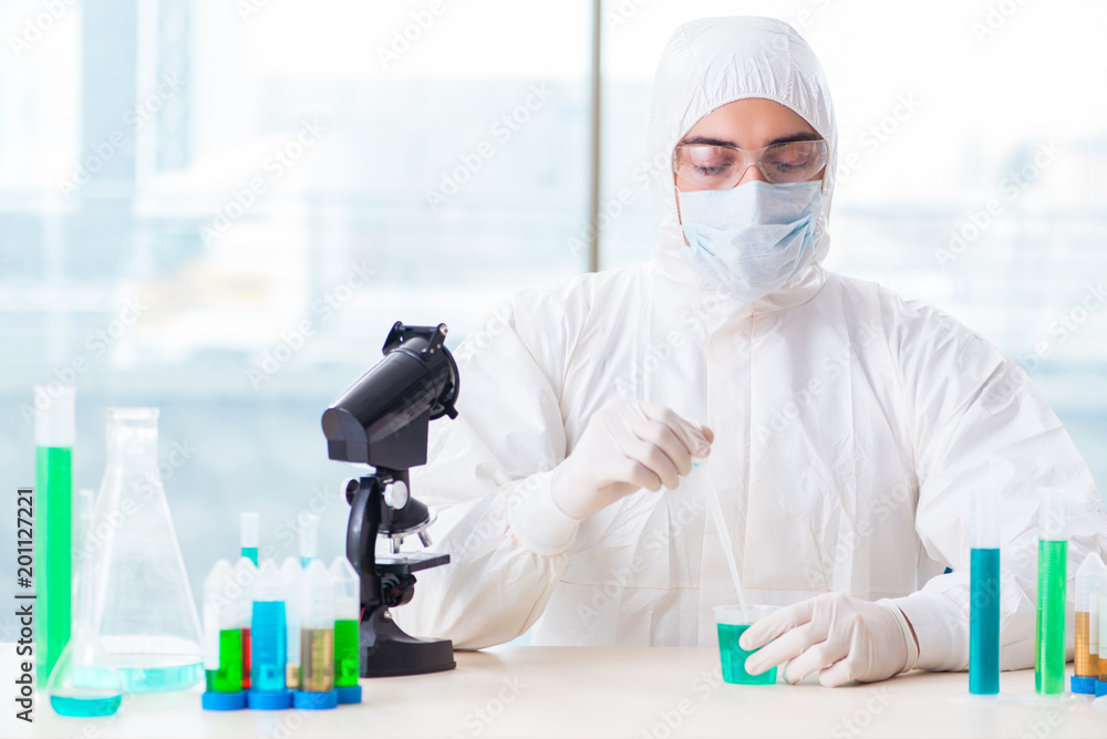 Young chemist student working in lab on chemicals Young chemist student working in lab on chemicals