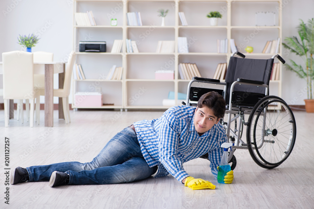Disabled man on wheelchair cleaning home Disabled man on wheelchair cleaning home