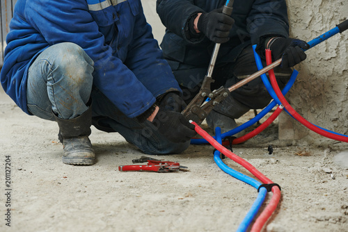 engineer repairmen installing heating system