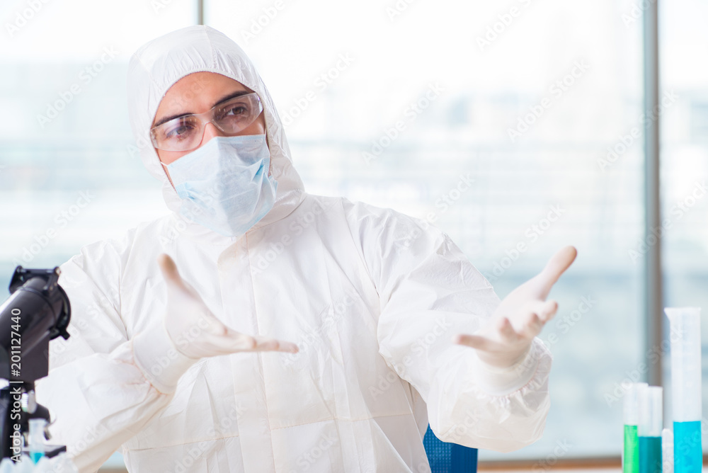 Young chemist student working in lab on chemicals Young chemist student working in lab on chemicals