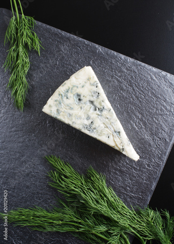 blue cheeseon a dark stone background photo