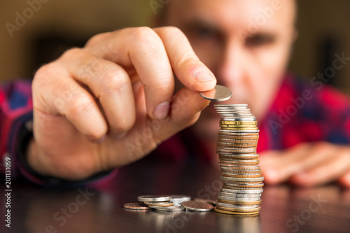 Fényképezés Man counts his coins on a table
