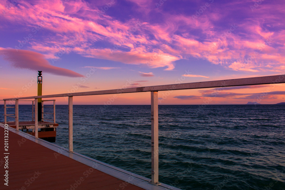 Obraz premium Pier. View of the sunset from the pier in Estepona. 