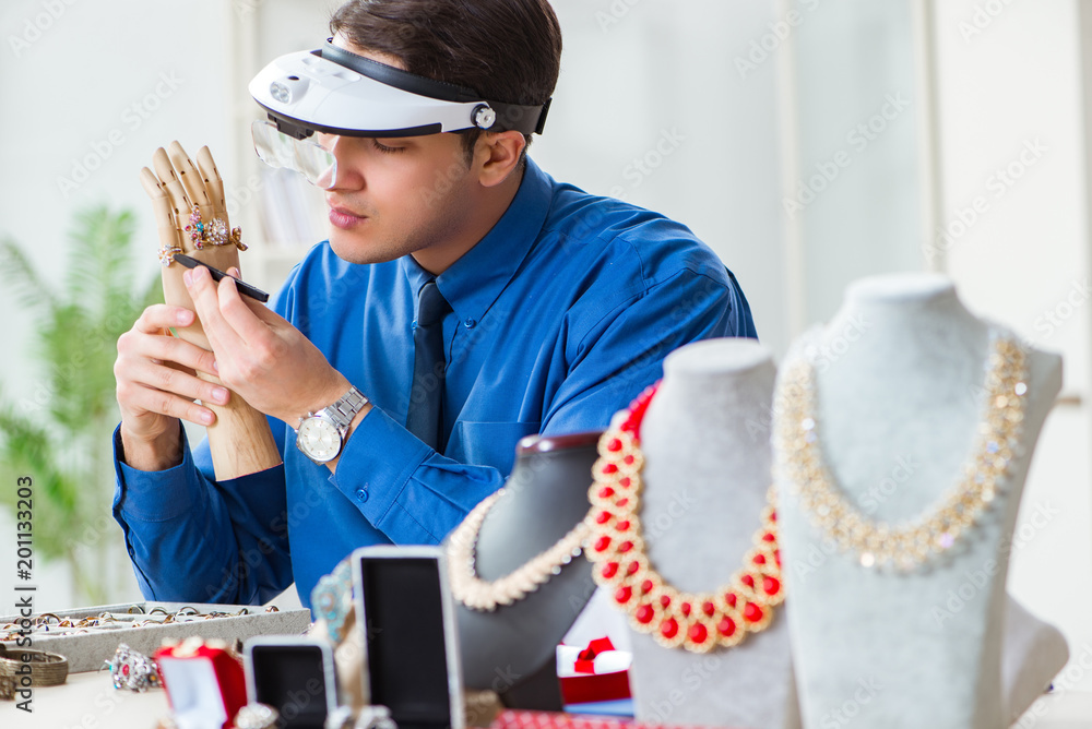 Jeweler working with luxury jewelry in the workshop Jeweler working with luxury jewelry in the workshop