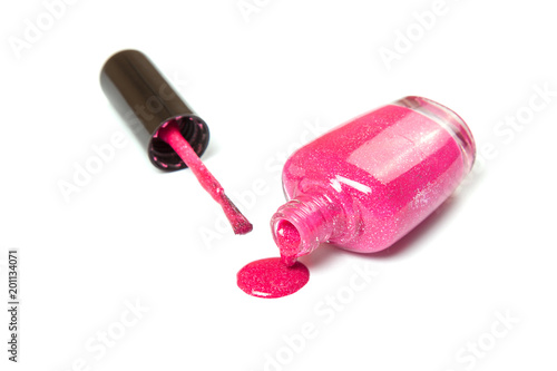 Nail polish of pink color on white isolated background.