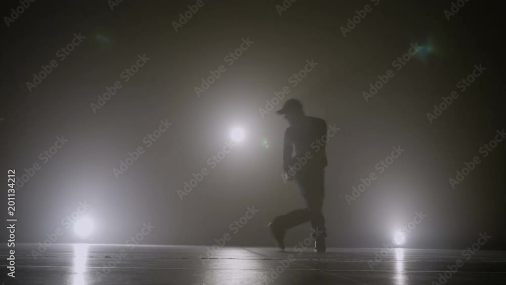 Famous singer performing hip hop dance style on the stage with smoke Famous singer performing hip hop dance style on the stage with smoke