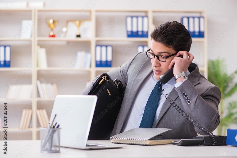 Businessman employee talking on the office phone Businessman employee talking on the office phone