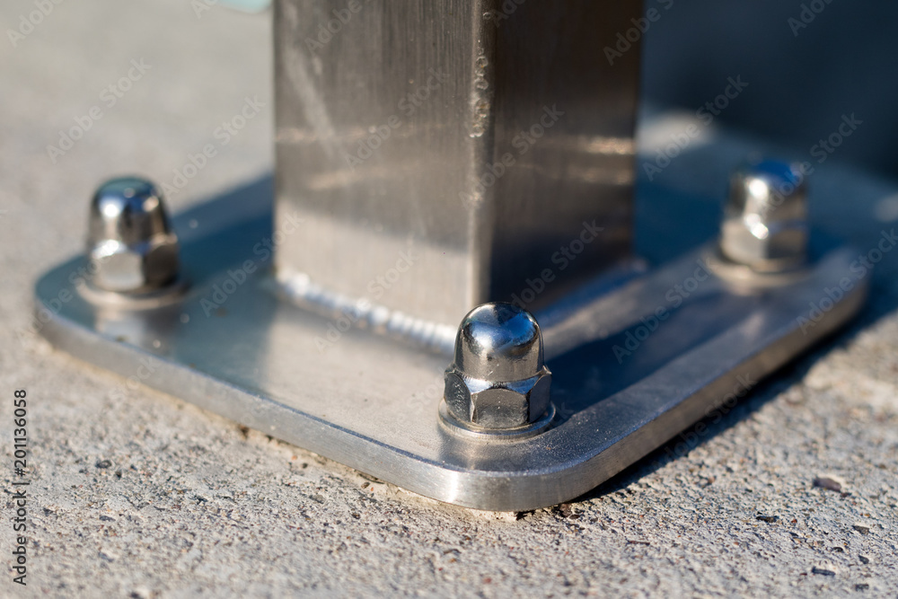 Nut and washer attached to the steel structure. Fixing of steel supports for concrete foundations. Nut and washer attached to the steel structure. Fixing of steel supports for concrete foundations.