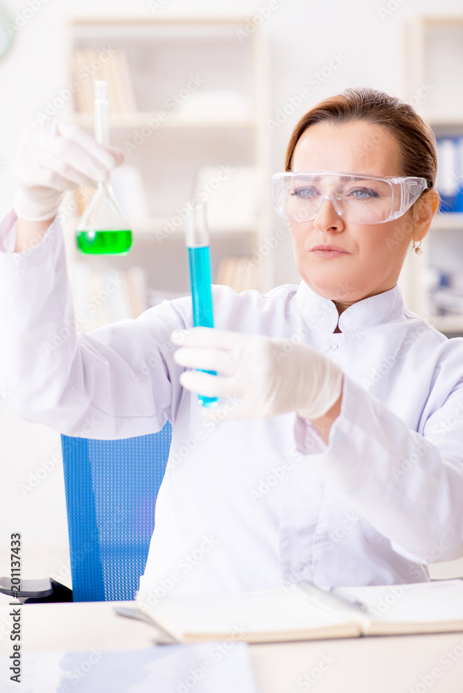 Woman chemist working in hospital clinic lab Woman chemist working in hospital clinic lab