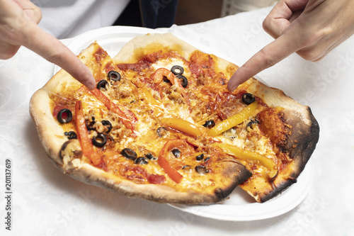 Man pointing at just made homemade pizza photo