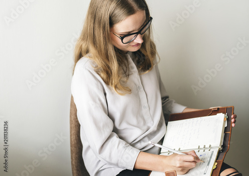 Caucasian woman taking a note