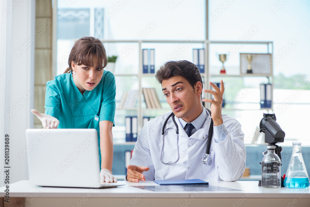 Fototapeta premium Doctor angry at his assistant due to medical error