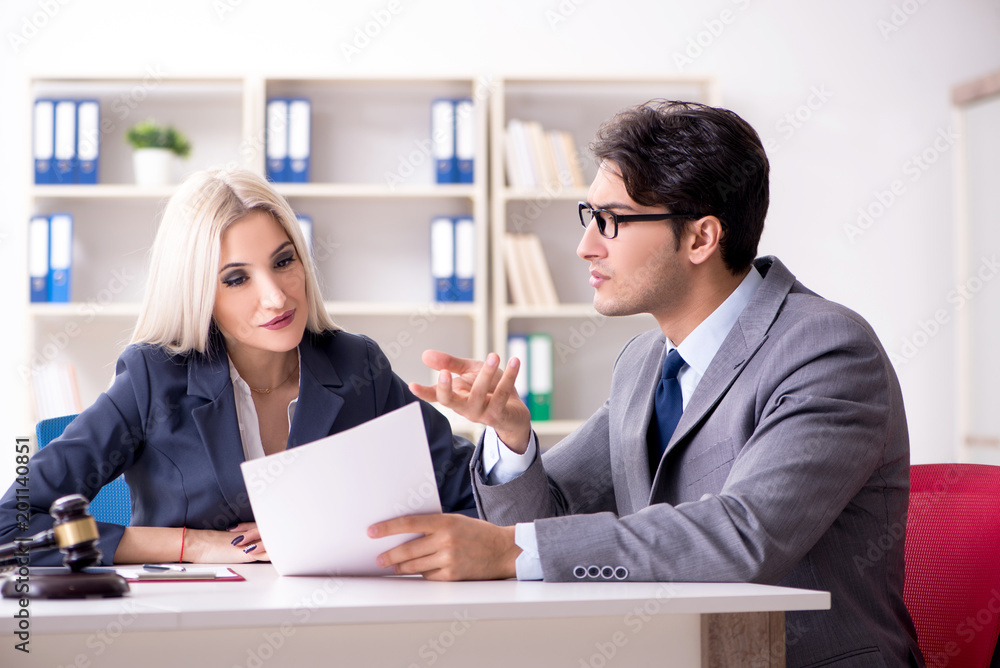 Lawyer discussing legal case with client Lawyer discussing legal case with client