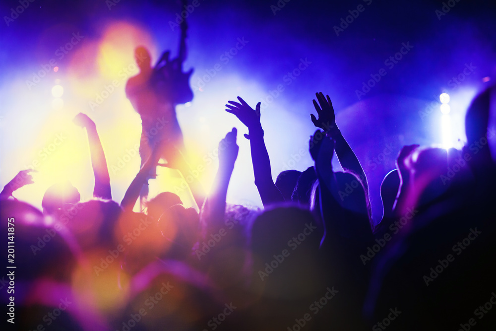 crowd with raised hands at concert - summer music festival crowd with raised hands at concert - summer music festival