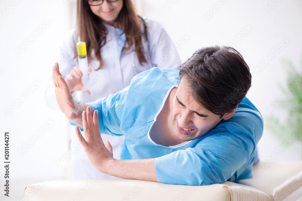Funny man getting ready for buttocks syringe shot Funny man getting ready for buttocks syringe shot