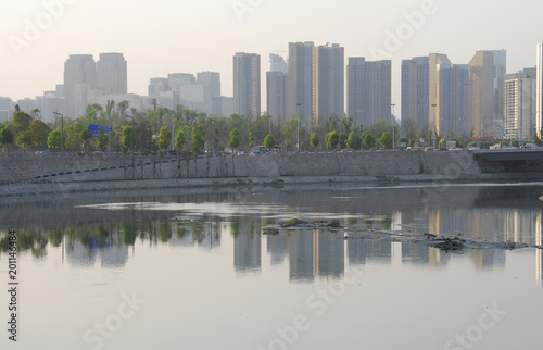 Fototapeta Naklejka Na Ścianę i Meble -  Air pollution with city skyline reflection in the river