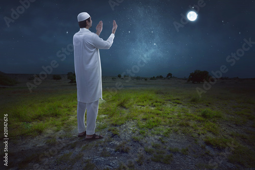 Rear view of asian muslim man praying