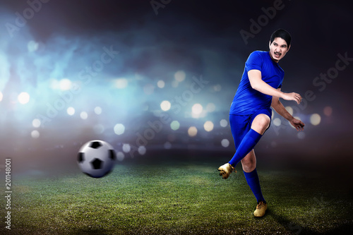 Young asian footballer man kicking the ball © Leo Lintang