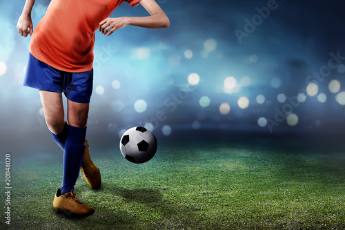 Female football player performing her skill with ball © Leo Lintang