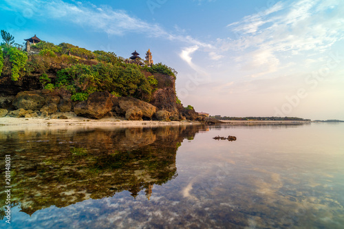 Geger beach and Pura Geger in Nusa Dua, Bali, Indonesia. Tradition Balian temple on cliffe over water photo