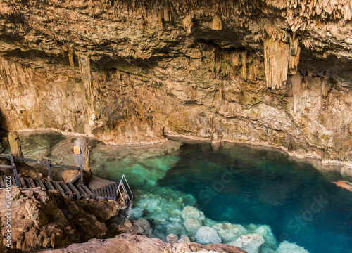 Photography beautiful natural pool of crystal clear water formed in a rocky cave with stalag