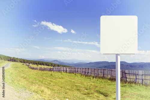 Blank Road Sign on Mountain Road at Summer Day