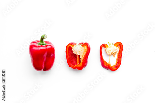 Layout of red sweet bell pepper slices on white background top view copy space