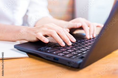 Female hands typing on her computer