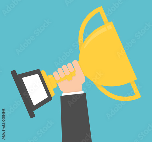 Hand holding and rising up golden trophy