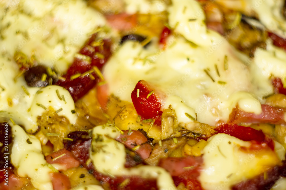 homemade pizza with peppers, plums, ham, sausage, cheese and spices, closeup homemade pizza with peppers, plums, ham, sausage, cheese and spices, closeup