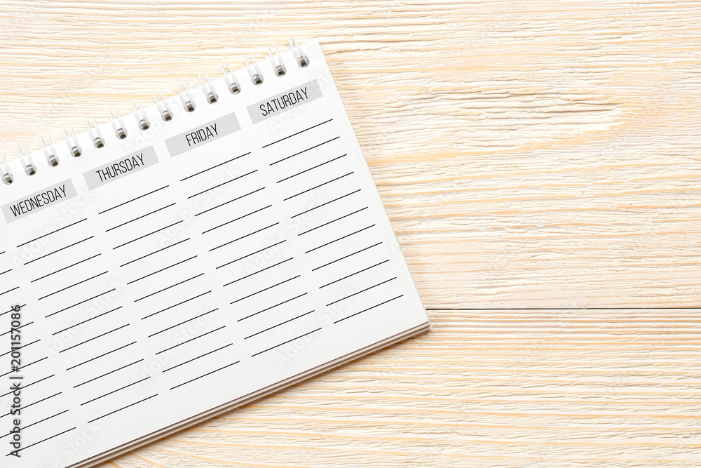 Obraz premium empty week planner on white office table, week end concept