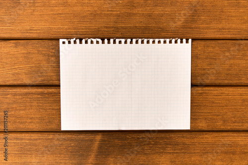 Clean sheet of paper on wooden background . Concept