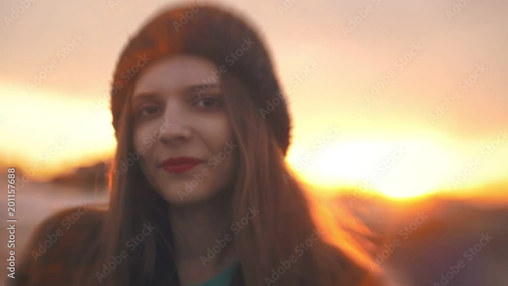 Portrait of beautiful young woman with red lips at sunset Portrait of beautiful young woman with red lips at sunset
