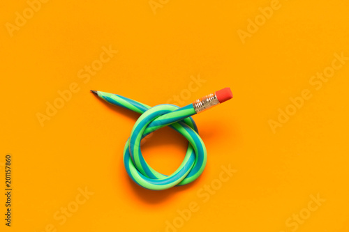  Flexible pencil . Isolated on orange background