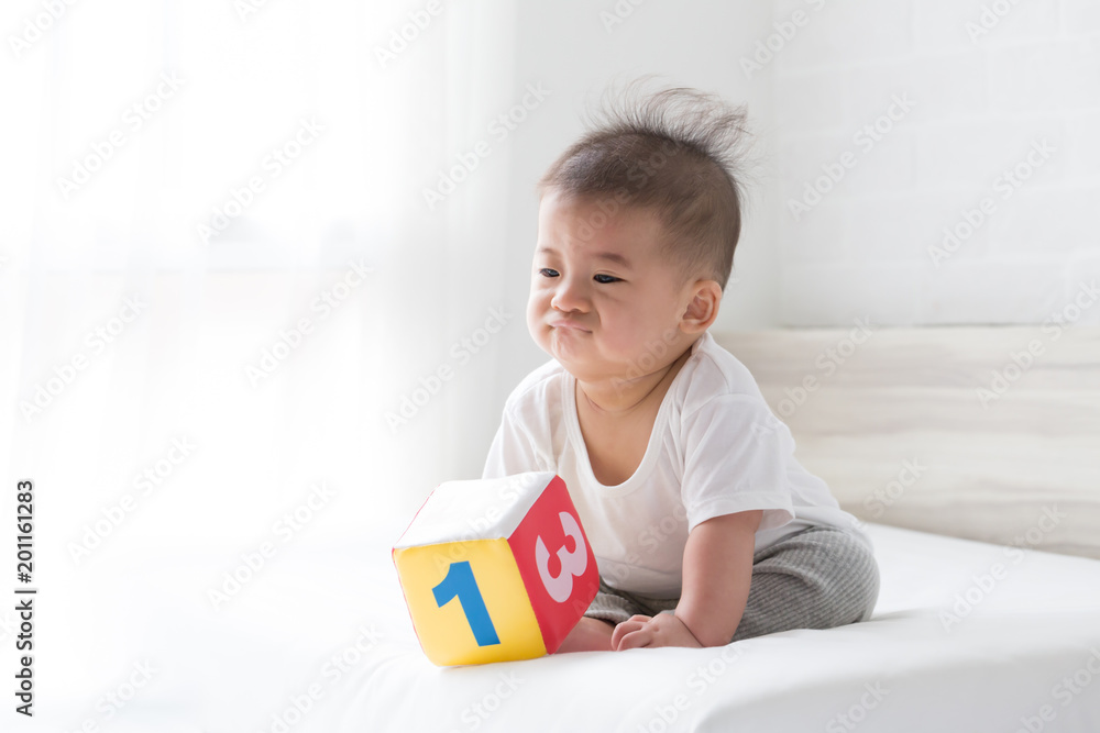 Asian baby boy be bored with toys Asian baby boy be bored with toys