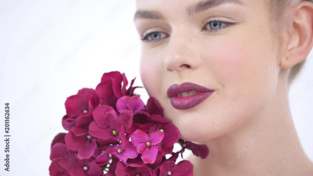 Closeup Beautiful face of an young woman with flowers Closeup Beautiful face of an young woman with flowers