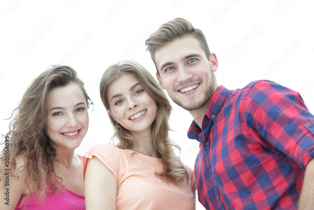 closeup of three young people smiling on white background closeup of three young people smiling on white background