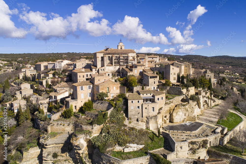 Aerial view of Gordes, labelled Most Beautiful Villages of France, perched on a rocky outcrop at the end of the Vaucluse plateau, 