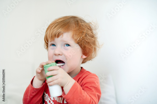 A boy sprinkles a medicine for a cold
