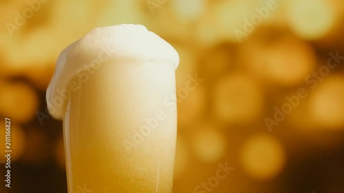 Pouring light beer into glass. 