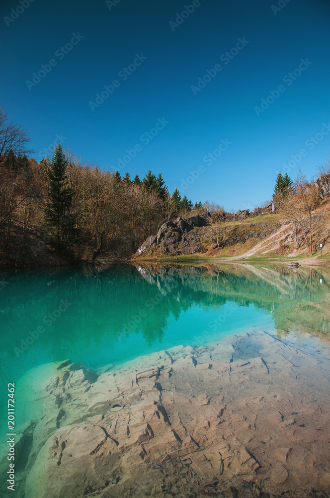 Beautiful blue mountain lake. The Blue Colour is caused by former limestone mining. (Blauer See, Hüttenrode near Blankenburg, National Park Harz in Germany
