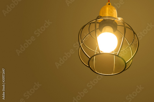 Modern lamps on ceiling on brown background. Modern lamps from curved steel.