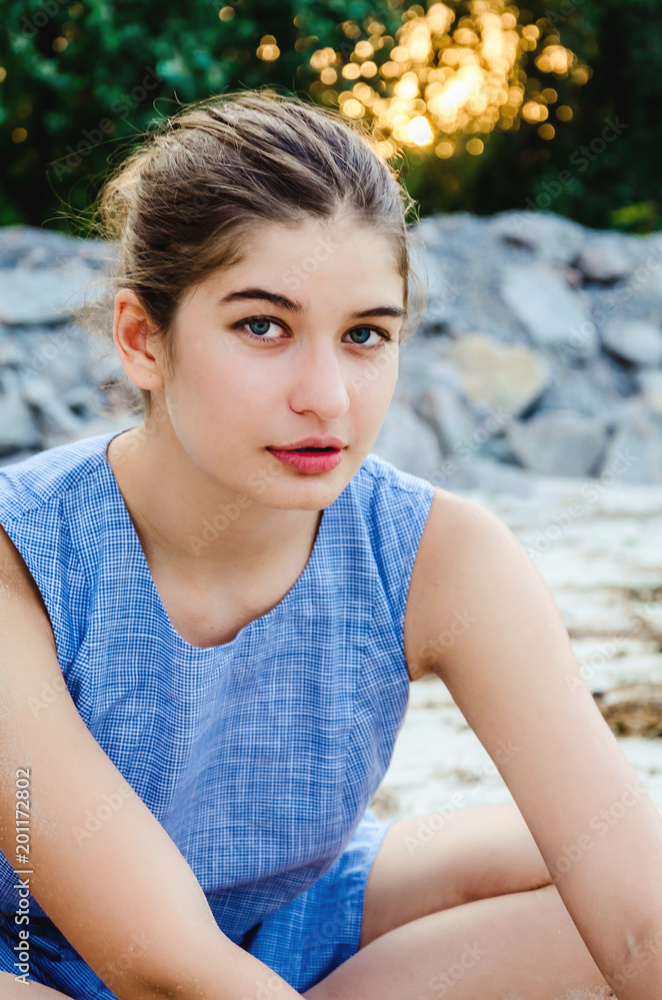 Portrait of a young beautiful girl on vacation. Closeup face of a