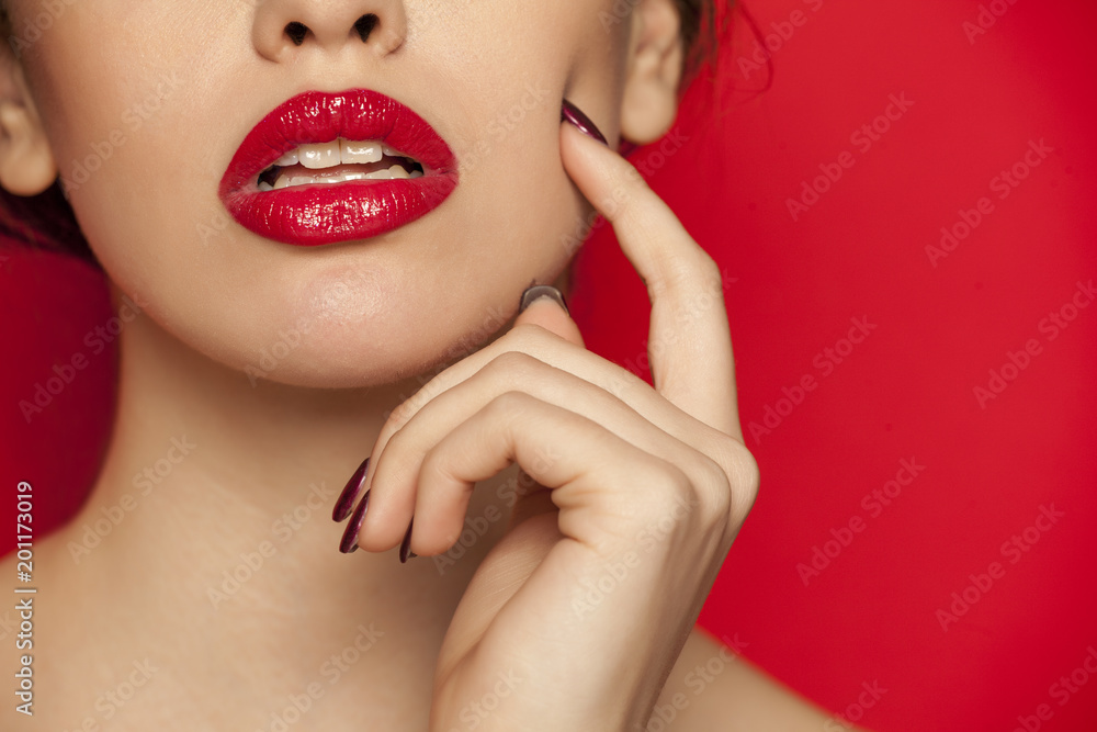 red glossy lipstick on red background - obrazy, fototapety, plakaty 