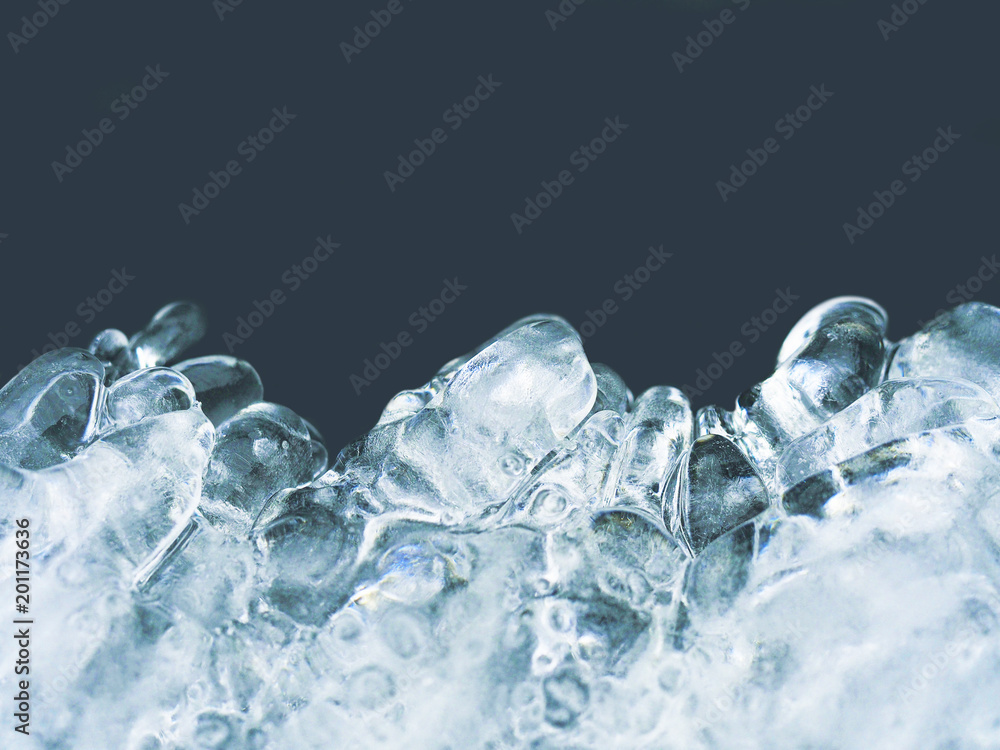 Natural ice texture isolated on a dark background close-up. Abstract background of ice structure. Freezing glacial, front view. Icy shape. Place for text Natural ice texture isolated on a dark background close-up. Abstract background of ice structure. Freezing glacial, front view. Icy shape. Place for text