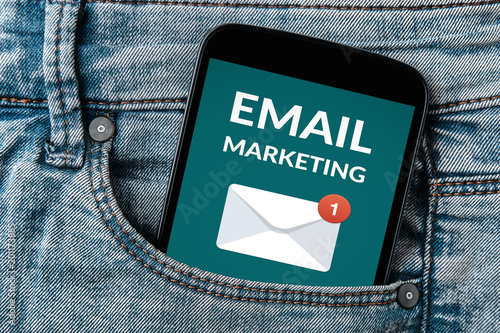 Email marketing concept on smartphone screen in jeans pocket. All screen content is designed by me. Flat lay