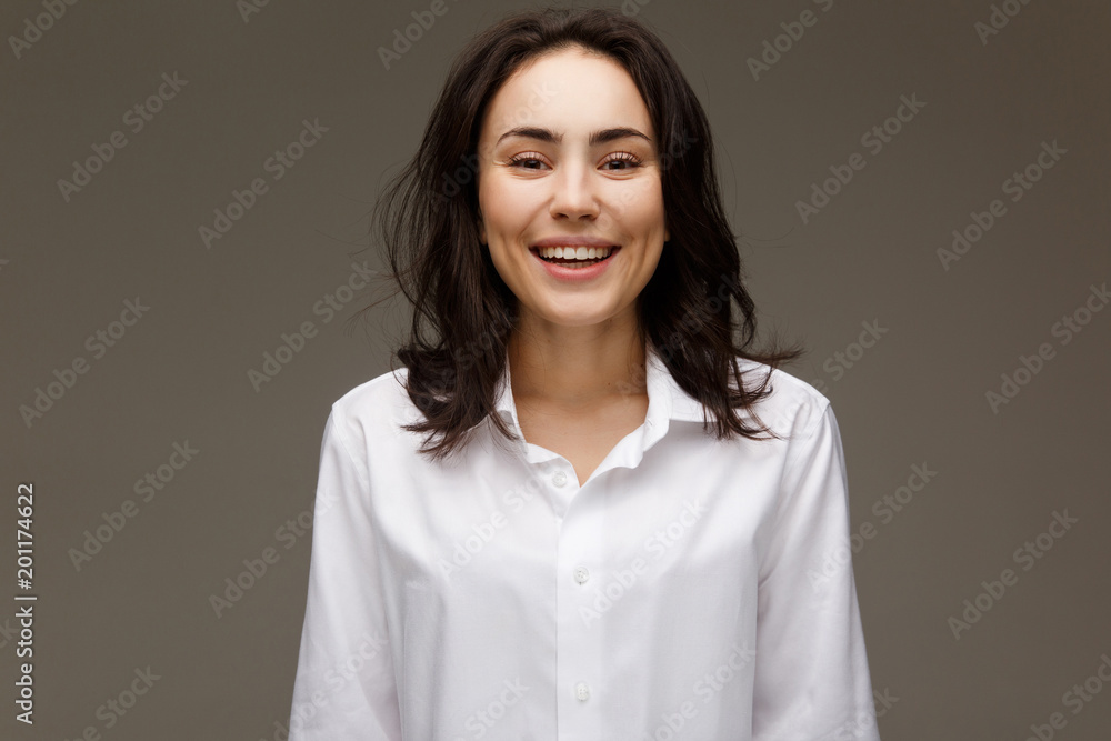 Beautiful girl in a white shirt shows emotions - smile, fun. Beautiful girl in a white shirt shows emotions - smile, fun.