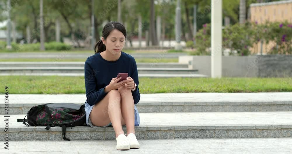 Woman waiting for her friends and use of smart watch and cellphone at outdoor Woman waiting for her friends and use of smart watch and cellphone at outdoor